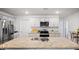 Modern kitchen featuring granite countertops, stainless steel appliances, and sleek white cabinetry at 2406 Lily Dr, Haw River, NC 27258