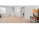 Upstairs loft area showcasing neutral walls, carpeted floor, and doors to additional rooms at 2406 Lily Dr, Haw River, NC 27258