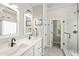 Bathroom boasts double sinks, modern fixtures, and a sleek glass-enclosed shower with tile surround at 2408 Fordcrest Dr, Apex, NC 27502