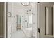 A view of a tiled shower with glass enclosure, featuring a built-in shower seat, and stylish fixtures at 2408 Fordcrest Dr, Apex, NC 27502