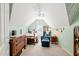 Charming bedroom featuring a vaulted ceiling, a day bed, and a reading nook with chair at 2408 Fordcrest Dr, Apex, NC 27502