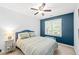Bedroom with a green striped bedspread, accent wall, window with natural light, and a bedside table at 2408 Fordcrest Dr, Apex, NC 27502