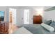 Bright bedroom featuring wood floors, white walls and trim, with an oak chest of drawers at 2408 Fordcrest Dr, Apex, NC 27502