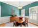 Dining room with teal walls, white trim, natural light, and traditional-style furniture at 2408 Fordcrest Dr, Apex, NC 27502