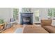 Close up of the fireplace with a mantel and windows to either side at 2408 Fordcrest Dr, Apex, NC 27502