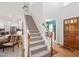 Bright and spacious foyer with hardwood floors, a staircase, and views into the living spaces at 2408 Fordcrest Dr, Apex, NC 27502