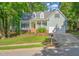 Charming home featuring a two-car garage, a manicured lawn, and mature trees in a desirable neighborhood at 2408 Fordcrest Dr, Apex, NC 27502