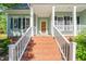 Inviting front porch with brick steps, white railings, and a beautiful wooden front door at 2408 Fordcrest Dr, Apex, NC 27502