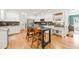 Bright kitchen with white cabinets, stainless steel appliances, and a dark, farmhouse-style island with seating at 2408 Fordcrest Dr, Apex, NC 27502