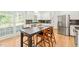 Well-lit kitchen featuring modern appliances, white cabinets, and a stylish eat-in island at 2408 Fordcrest Dr, Apex, NC 27502