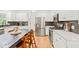 Beautifully renovated kitchen featuring white cabinets, stainless steel appliances, and a modern backsplash at 2408 Fordcrest Dr, Apex, NC 27502