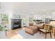 Open-concept living room with a fireplace, hardwood floors, and views into the updated kitchen at 2408 Fordcrest Dr, Apex, NC 27502
