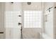 Close-up view of the glass shower with elegant tile and black hardware, including a rain shower head at 2408 Fordcrest Dr, Apex, NC 27502