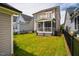 Spacious backyard with lush grass, a fence, and a covered porch perfect for outdoor living at 249 Salt Cedar Ln, Chapel Hill, NC 27516