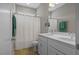 Bathroom with double sink vanity, large mirror, tiled floors, and shower with curtain at 249 Salt Cedar Ln, Chapel Hill, NC 27516