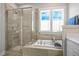 Modern bathroom featuring a soaking tub, frameless glass shower, and custom cabinetry with an abundance of natural light at 249 Salt Cedar Ln, Chapel Hill, NC 27516