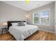 Bright bedroom with a queen bed, wood floors, natural lighting, and neutral paint at 249 Salt Cedar Ln, Chapel Hill, NC 27516