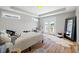 Stylish bedroom featuring a cozy bed, a walkout balcony, and a full-length mirror, complemented by modern decor at 249 Salt Cedar Ln, Chapel Hill, NC 27516