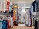 Spacious walk-in closet with custom shelving, hanging rods, and hardwood floors for optimal organization and storage at 249 Salt Cedar Ln, Chapel Hill, NC 27516