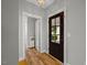 Inviting foyer with hardwood floors, stylish lighting, and a glimpse of the front yard at 249 Salt Cedar Ln, Chapel Hill, NC 27516