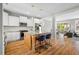 Modern kitchen featuring white cabinets, an island with bar stools and stainless steel appliances at 249 Salt Cedar Ln, Chapel Hill, NC 27516