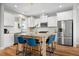 Bright kitchen with stainless steel appliances, a central island and modern pendant lights at 249 Salt Cedar Ln, Chapel Hill, NC 27516