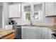 Bright kitchen features white cabinetry, granite countertops, and modern fixtures at 249 Salt Cedar Ln, Chapel Hill, NC 27516