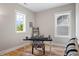 Bright home office space with hardwood floors, neutral paint, and two windows for natural lighting at 249 Salt Cedar Ln, Chapel Hill, NC 27516