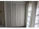 Bedroom closet with white bifold doors, paired with soft light filtering through sheer curtains at 2519 Hitchcock Dr, Durham, NC 27705