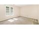 Bedroom with neutral walls and carpet, featuring a large window for natural light at 2519 Hitchcock Dr, Durham, NC 27705