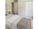 Bright bedroom featuring a large bed, neutral colors, and a sitting bench at 2519 Hitchcock Dr, Durham, NC 27705