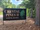 Community sign for Crystal Pines II Townhomes surrounded by trees at 2519 Hitchcock Dr, Durham, NC 27705