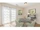 Charming dining area with a marble table, soft green chairs and ample natural light at 2519 Hitchcock Dr, Durham, NC 27705