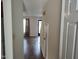 View of the hallway leading into a living room with hardwood floors and a neutral color palette at 2519 Hitchcock Dr, Durham, NC 27705