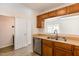 Stainless steel dishwasher and double sink with wood-look countertops at 2519 Hitchcock Dr, Durham, NC 27705