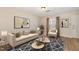 Bright living room featuring a modern sofa, decorative rug, and stylish coffee tables, creating an inviting space at 2519 Hitchcock Dr, Durham, NC 27705