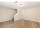 Spacious living room with wood-look floors, stairway and access to additional rooms providing a versatile layout at 2519 Hitchcock Dr, Durham, NC 27705