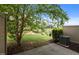Backyard and patio with manicured lawn and mature trees at 256 Rubrum Dr, Hillsborough, NC 27278