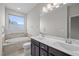 Bright bathroom featuring a double sink vanity, soaking tub, and tile flooring at 256 Rubrum Dr, Hillsborough, NC 27278