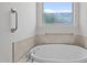 Bathroom with soaking tub, privacy window and grab bars at 256 Rubrum Dr, Hillsborough, NC 27278