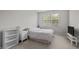 Light bedroom featuring a window and bedside tables at 256 Rubrum Dr, Hillsborough, NC 27278
