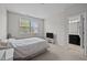 Cozy bedroom with a neutral color scheme, large window, and an ensuite bathroom at 256 Rubrum Dr, Hillsborough, NC 27278