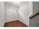 Bright foyer showcasing hardwood floors, a side-light window and a white entry door at 256 Rubrum Dr, Hillsborough, NC 27278