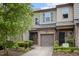 Charming townhome with stone accents, neutral siding, well maintained landscaping and a one-car garage at 256 Rubrum Dr, Hillsborough, NC 27278