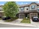 Beautiful townhome exterior with manicured landscaping, stone accents, and attached garages at 256 Rubrum Dr, Hillsborough, NC 27278