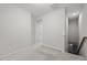Hallway with plush carpet, neutral walls, and access to the staircase at 256 Rubrum Dr, Hillsborough, NC 27278