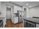 Updated kitchen with stainless steel appliances, gray backsplash, and white cabinets at 256 Rubrum Dr, Hillsborough, NC 27278