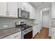 Kitchen featuring stainless steel gas range, microwave and granite countertops at 256 Rubrum Dr, Hillsborough, NC 27278