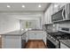 Bright, modern kitchen with granite countertops and stainless steel appliances at 256 Rubrum Dr, Hillsborough, NC 27278