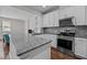 Bright kitchen featuring granite counters, stainless steel appliances, a sizable island, and modern white cabinets at 256 Rubrum Dr, Hillsborough, NC 27278